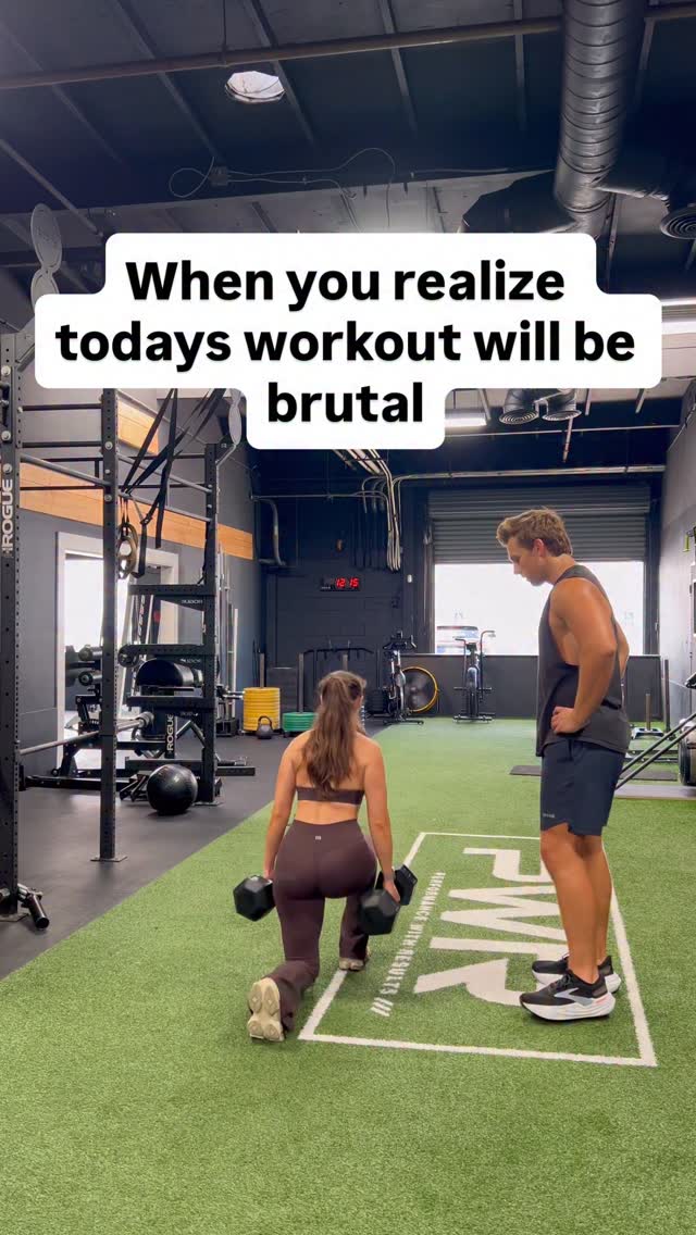 Nick training a client with dumbbells in the gym